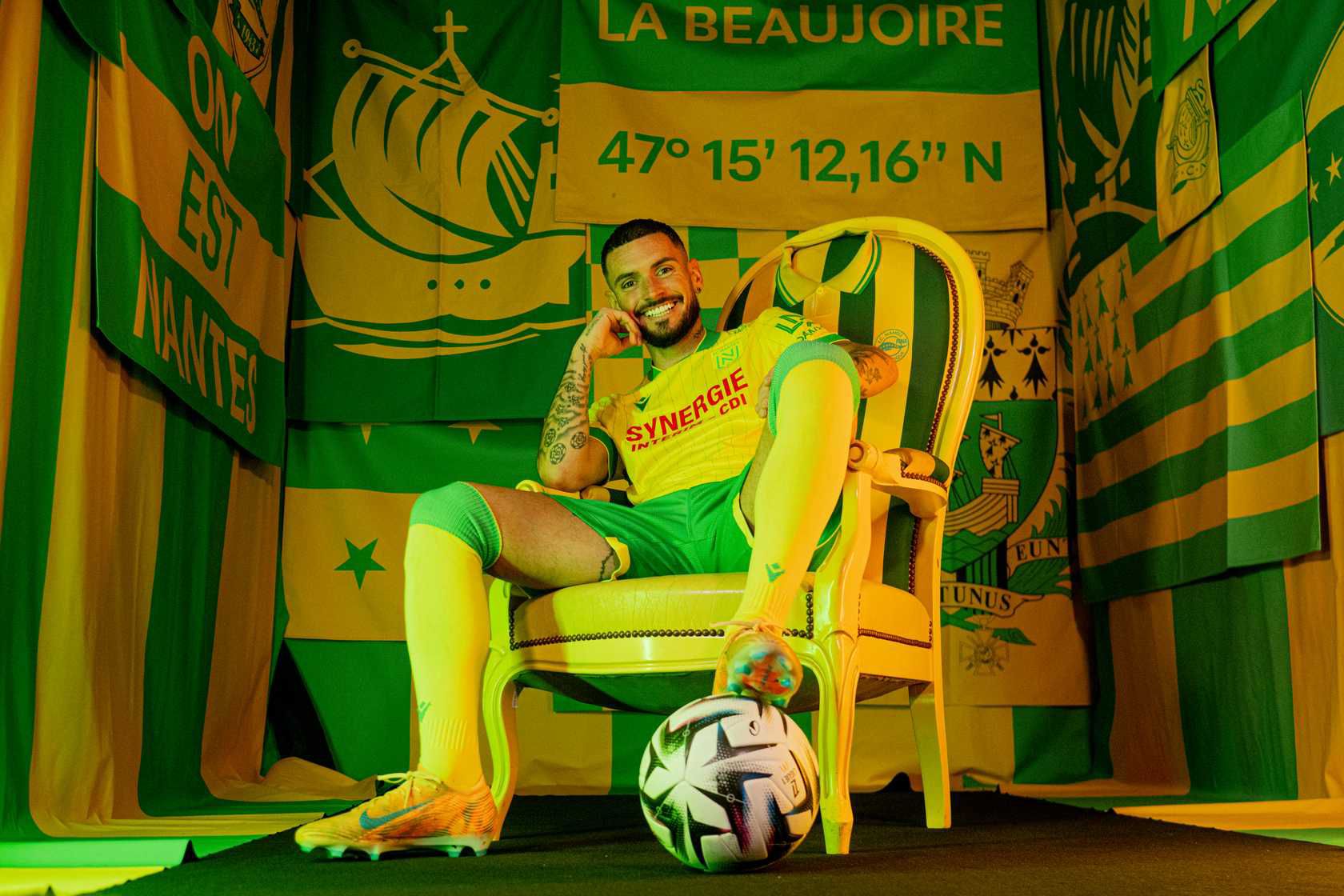 Rémy Cabella assis sur le trône devant le décor La Beaujoire